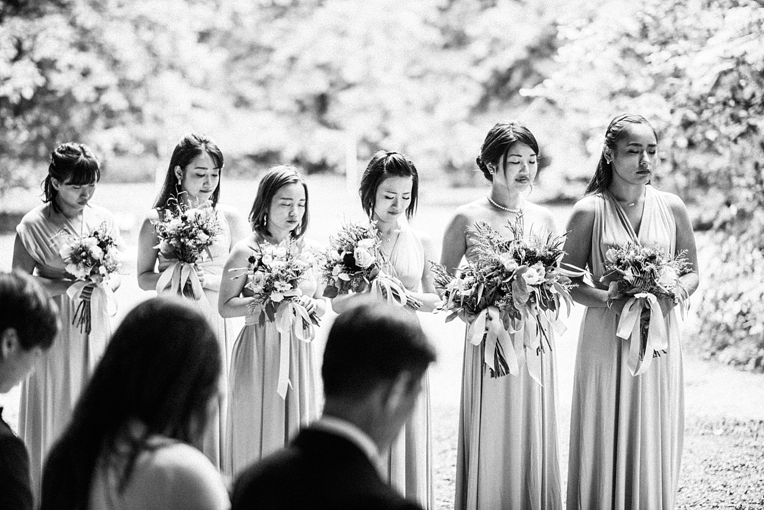 bridal party closed their eyes and blessed for their love and relationship