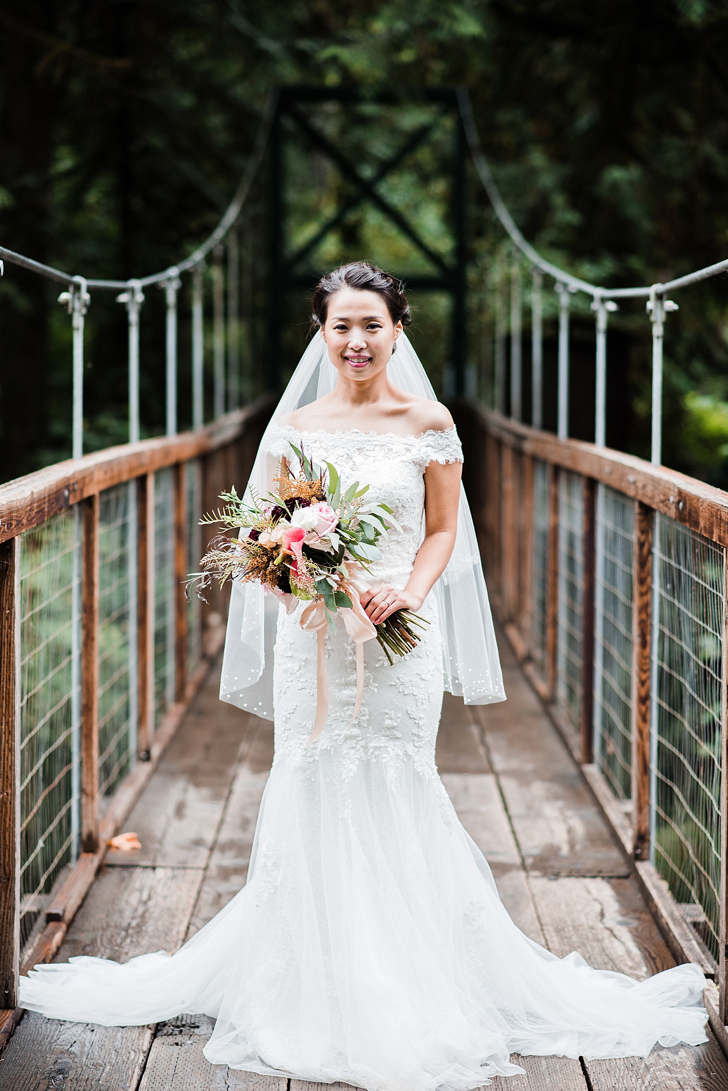 a bride looks at the camera with her bouquet in her hand